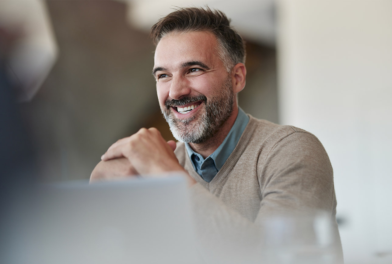 Smiling professional at his desk